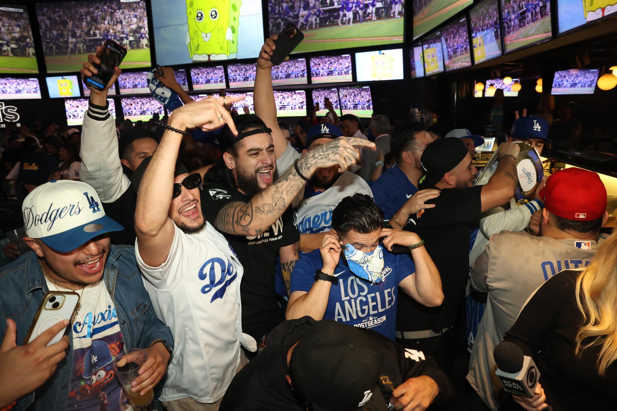 Dodgers fans celebrate as the Los Angeles Dodgers win against the New York Yankees in Game 5.