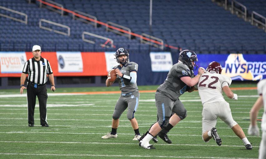 Moravia’s Thomas Palmer drops back to throw a pass earlier this season at the JMA Wireless Dome.