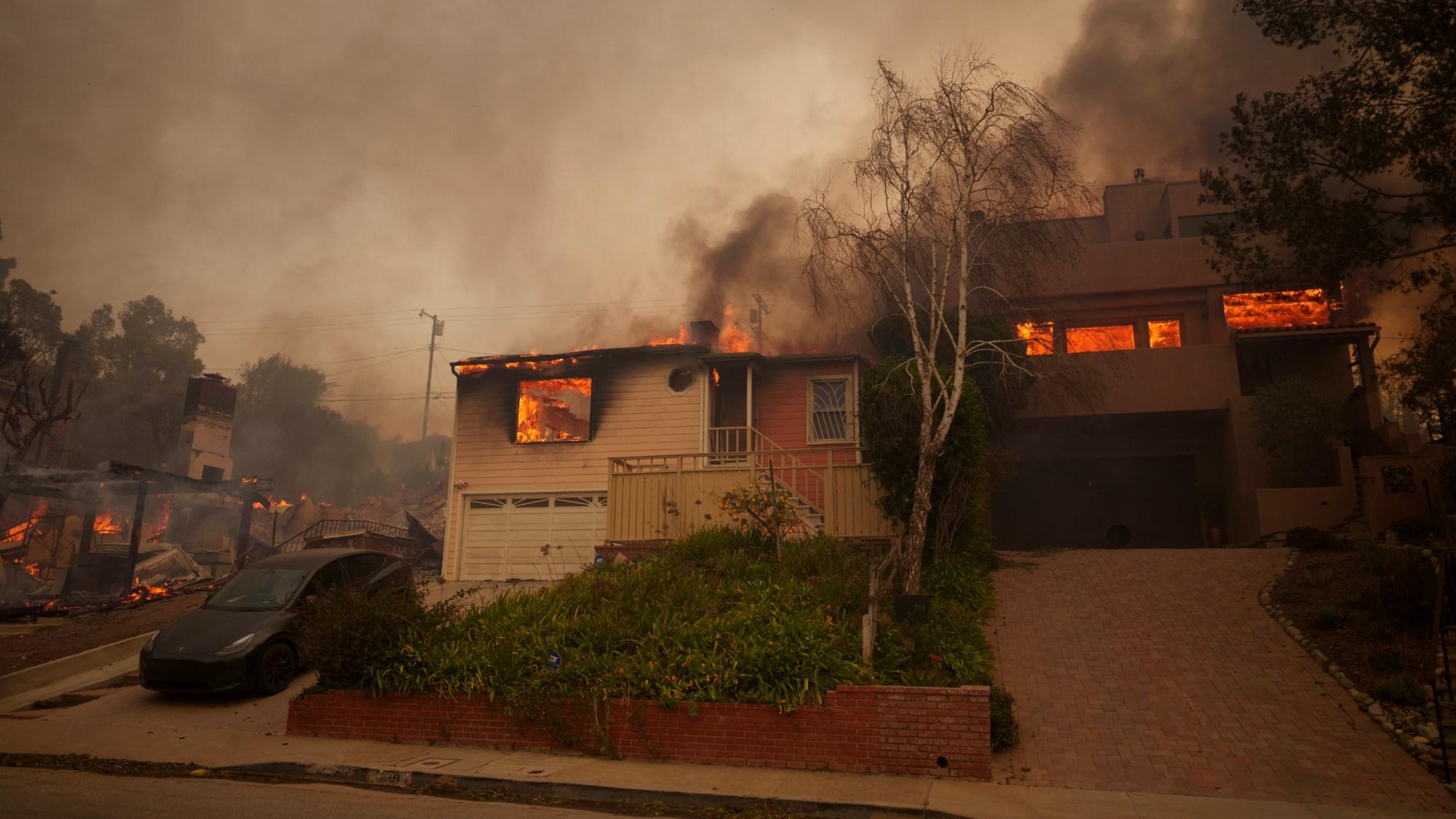 Flames from the Palisades Fire burn a home on January 8, 2025 in the Pacific Palisades neighborhood.