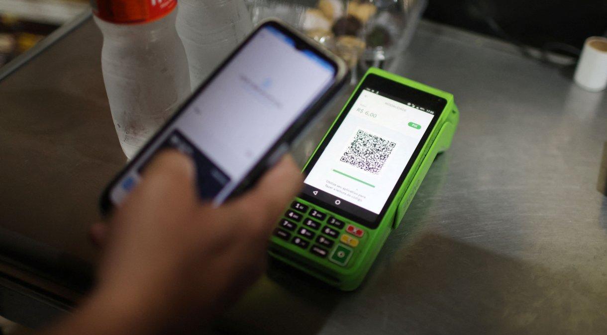 Pessoa faz pagamento por PIX com celular em loja do Rio de Janeiro