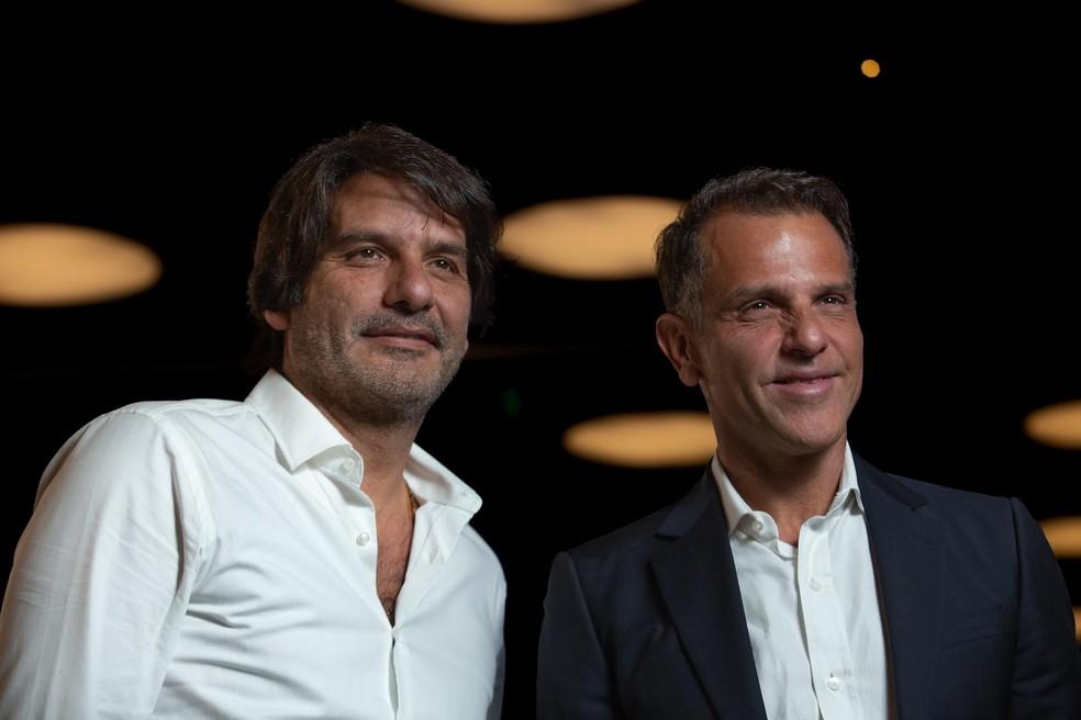 Jatahy e Birman durante o anúncio da fusão, refletindo sobre a desarmonia na gestão.