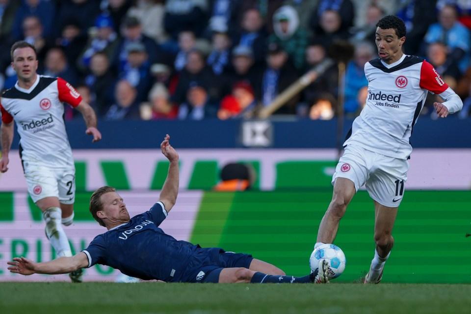 Hugo Ekitike of Frankfurt dribbling the ball past an opponent during a soccer match