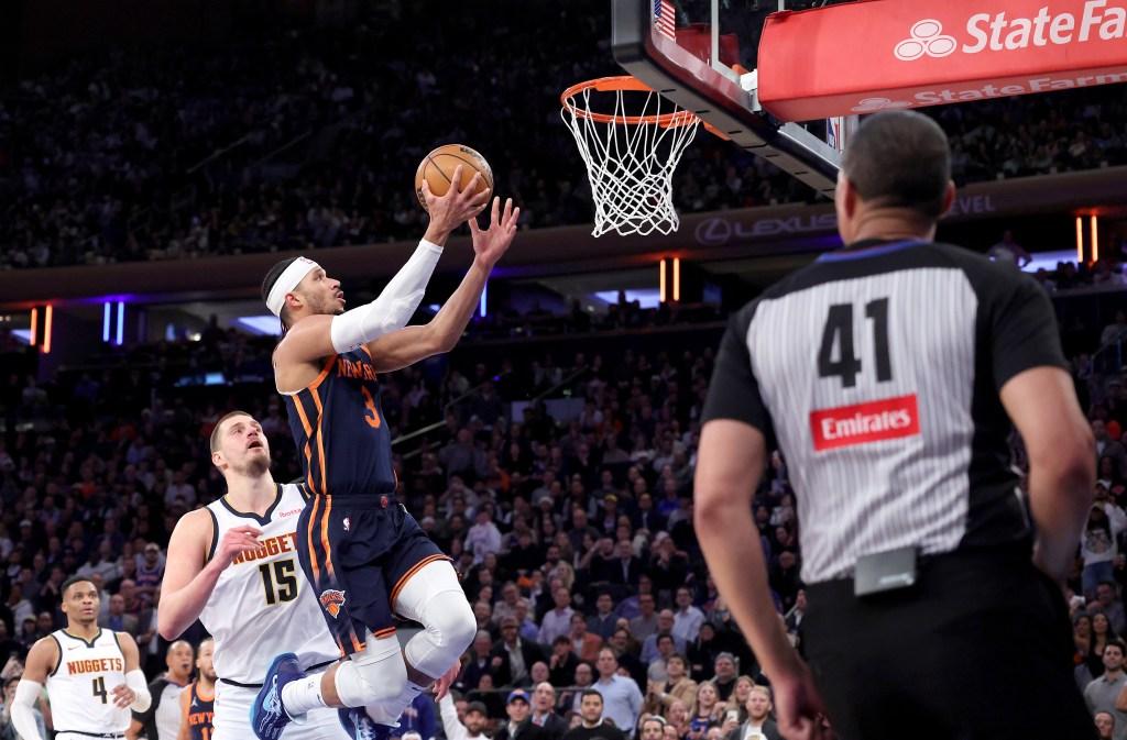 Knicks guard Josh Hart puts up a shot in front of Nikola Jokic
