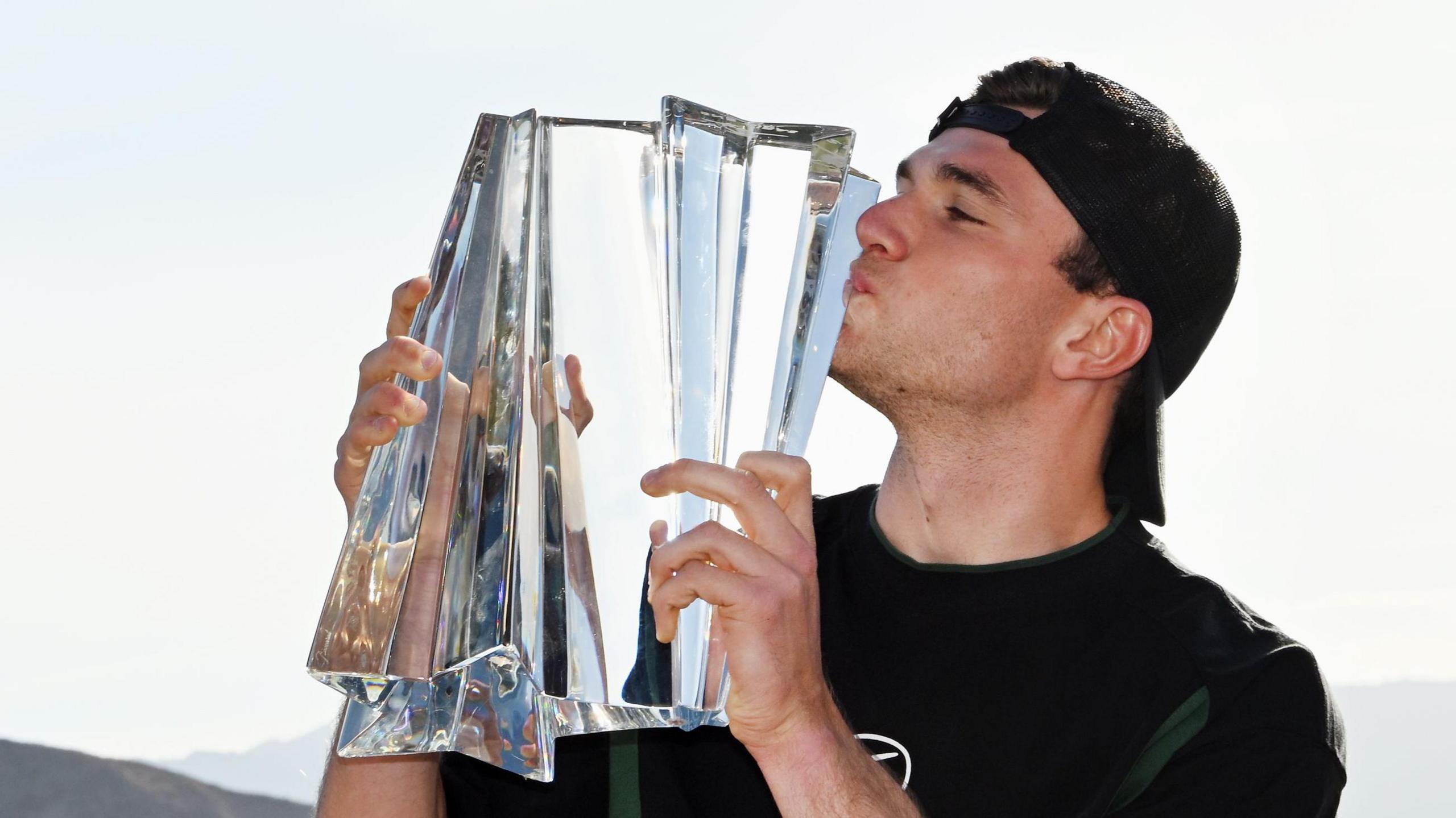 Jack Draper celebrates with the Indian Wells trophy.