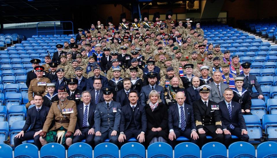 Group photo of Rangers directors, armed forces personnel, and Barry Ferguson at Ibrox Stadium for Armed Forces Day