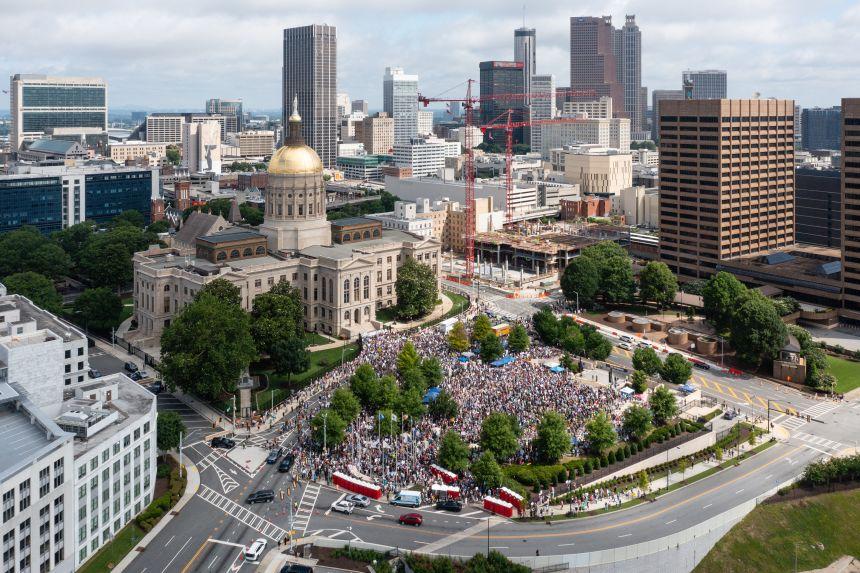 Pessoas participando do protesto 'No Kings' em Atlanta, em frente ao Capitólio do Estado da Geórgia.