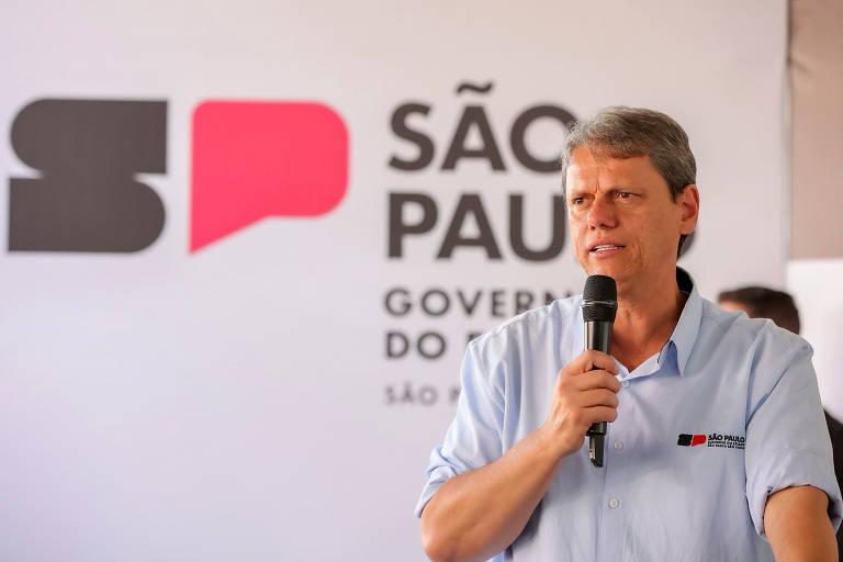 Governador Tarcísio de Freitas falando ao microfone em evento.