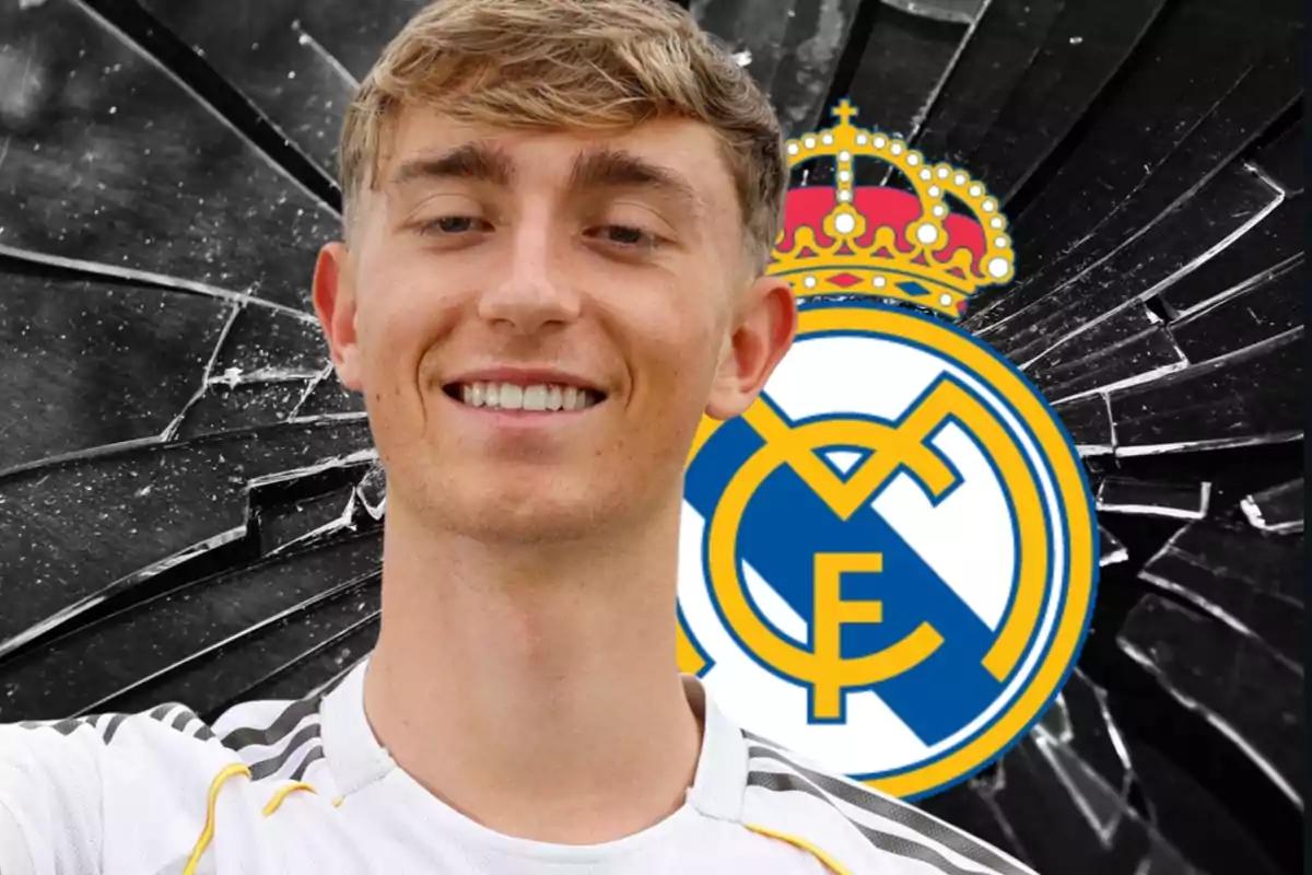 Young man in a white t-jersey smiles in front of the Real Madrid crest and a background of broken glass.