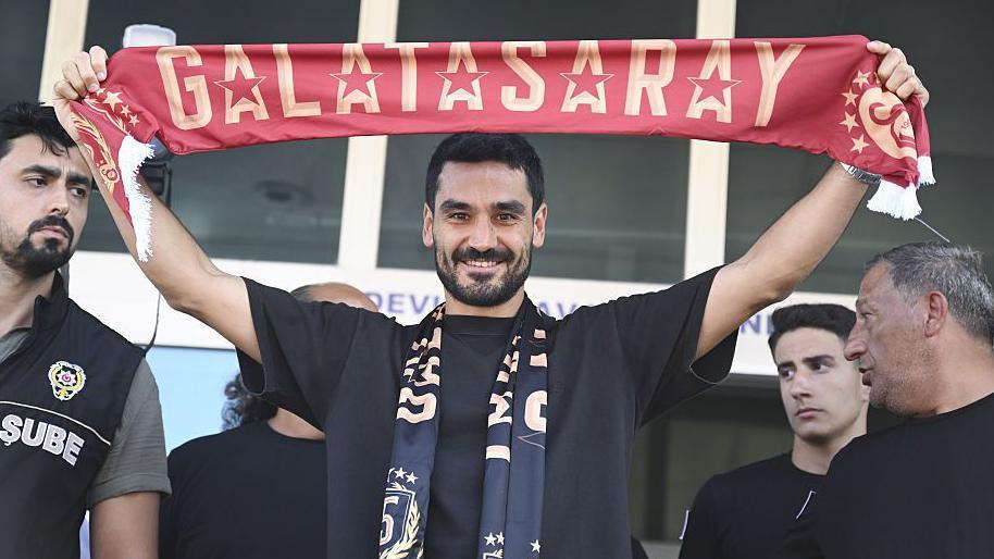 Ilkay Gundogan segura um lenço do Galatasaray acima da cabeça.