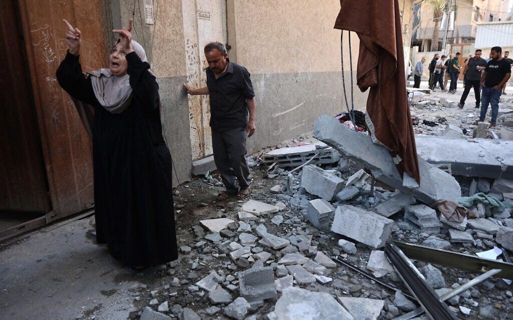 A woman reacts following an Israeli airstrike in the al-Sabra neighborhood of Gaza City