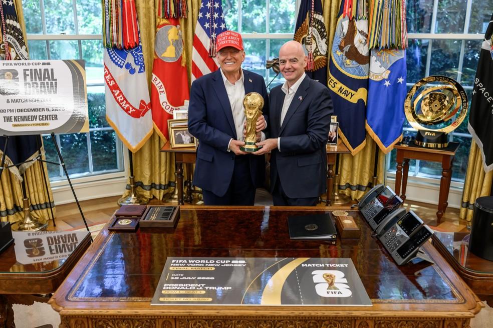 Presidente dos Estados Unidos, Donald Trump, e presidente da Fifa, Gianni Infantino, posam para foto com o troféu da Copa do Mundo no Salão Oval, na Casa Branca. Foto de agosto de 2025.